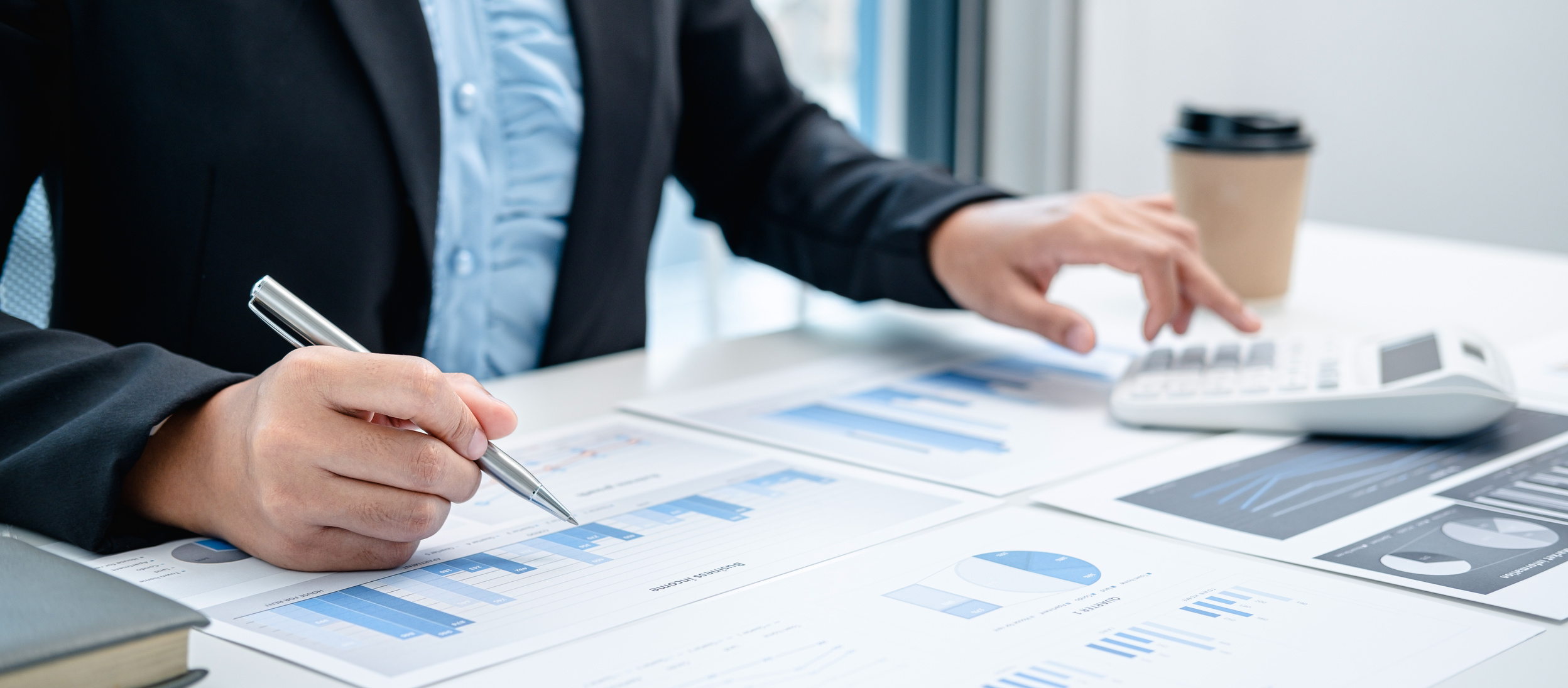 Business Woman Are Working by Reviewing the Numeric Data from Graphs